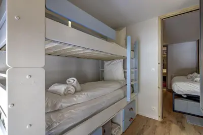 two bunk beds in a room with a mirror at Fontanes - Duplex 200m Grands Montets Balcon Vue Parking in Chamonix-Mont-Blanc