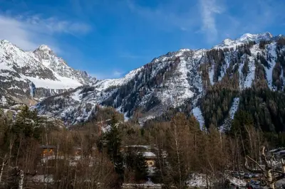 a snow covered mountain with a house in the foreground at Fontanes - Duplex 200m Grands Montets Balcon Vue Parking in Chamonix-Mont-Blanc