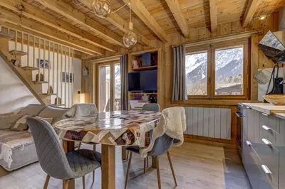 a kitchen and dining room with a table and chairs at Namaste - Cosy 2CH Vue Remontee 500m Parking in Les Houches