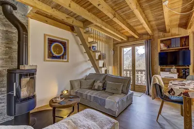 a living room with a couch and a fireplace at Namaste - Cosy 2CH Vue Remontee 500m Parking in Les Houches