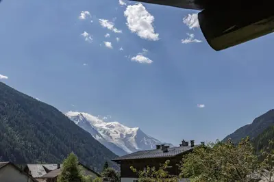 a view of a snow covered mountain from a house at Beugeant - Cosy Chalet 140m2 Vues Calme Garage in Chamonix-Mont-Blanc