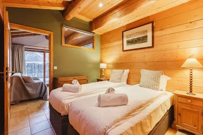 a bedroom with a large bed in a room with wooden walls at Beugeant - Cosy Chalet 140m2 Vues Calme Garage in Chamonix-Mont-Blanc