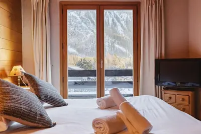 a bedroom with a bed with a view of a mountain at Beugeant - Cosy Chalet 140m2 Vues Calme Garage in Chamonix-Mont-Blanc
