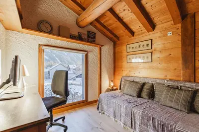 a bedroom with a bed and a desk with a computer at Beugeant - Cosy Chalet 140m2 Vues Calme Garage in Chamonix-Mont-Blanc