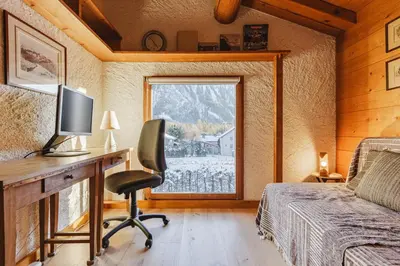 a bedroom with a desk with a computer and a window at Beugeant - Cosy Chalet 140m2 Vues Calme Garage in Chamonix-Mont-Blanc