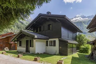 a black and white house with mountains in the background at Beugeant - Cosy Chalet 140m2 Vues Calme Garage in Chamonix-Mont-Blanc
