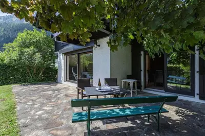 a picnic table and chairs sitting on a patio at Beugeant - Cosy Chalet 140m2 Vues Calme Garage in Chamonix-Mont-Blanc