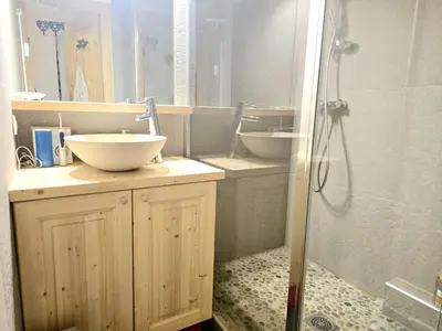 a bathroom with two sinks and a shower at Charming duplex in Hameau des Pistes ski in ski out in Megève