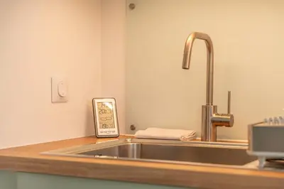 a kitchen counter with a sink and a thermometer at Apartment Le Valleen in Saint-Gervais-les-Bains