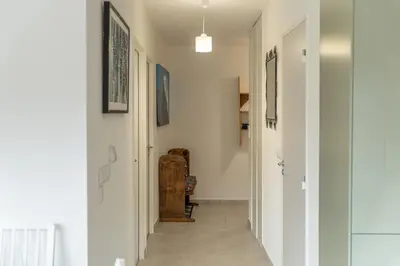 a hallway of a home with white walls and white floors at Apartment Le Valleen in Saint-Gervais-les-Bains