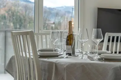 a table with a bottle of wine and glasses on it at Apartment Le Valleen in Saint-Gervais-les-Bains