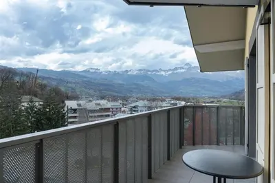 a balcony with a table and a view of mountains at Apartment Le Valleen in Saint-Gervais-les-Bains