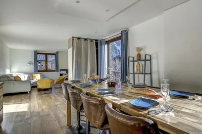 a dining room with a large wooden table and chairs at Lac - Cosy 120m2 Vues MtBlanc Flegere 5mn Lac Golf in Chamonix-Mont-Blanc