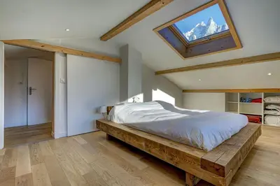 a bedroom with a bed and a skylight at Lac - Cosy 120m2 Vues MtBlanc Flegere 5mn Lac Golf in Chamonix-Mont-Blanc