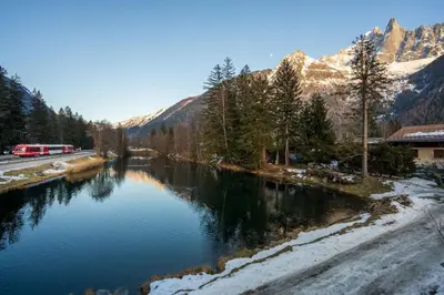 a river in the mountains with snow on the ground at Lac - Cosy 120m2 Vues MtBlanc Flegere 5mn Lac Golf in Chamonix-Mont-Blanc