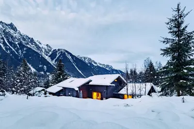 a cabin in the snow with mountains in the background at Yagire - Charmant Mazot 4pax HomeCine Nature Terrasse in Chamonix-Mont-Blanc