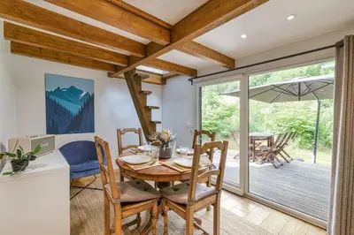 a dining room with a wooden table and chairs at Yagire - Charmant Mazot 4pax HomeCine Nature Terrasse in Chamonix-Mont-Blanc