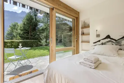 a bedroom with a bed and a large window at KV - Moderne 2CH Vue MtBlanc Terrasse Brevent 3mn in Chamonix-Mont-Blanc
