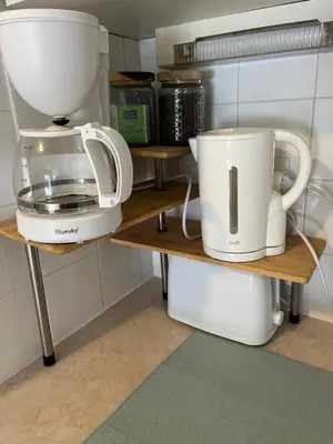 a coffee maker and a blender on shelves in a kitchen at Studio confortable dans résidence avec piscine in Samoëns