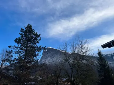 a view of a mountain with trees and a sky at Studio confortable dans résidence avec piscine in Samoëns