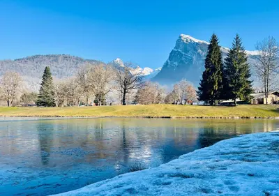 a view of a lake with a mountain in the background at Studio confortable dans résidence avec piscine in Samoëns