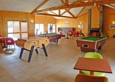 a large room with several tables and pool tables at Studio confortable dans résidence avec piscine in Samoëns