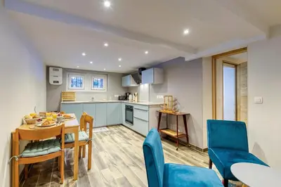 a kitchen and dining room with a table and chairs at Lou Dava Chic Apt Near Centre Chamonix - Happy Rentals in Chamonix-Mont-Blanc