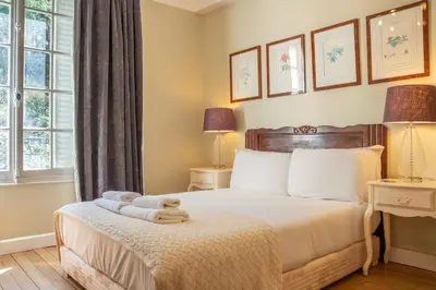 a bedroom with a bed with a teddy bear on it at Timeless Elegance, 2 bed Apt in Historical Building St Gervais in Saint-Gervais-les-Bains