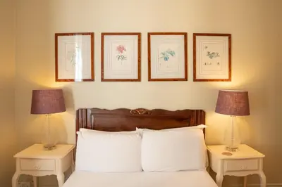 a bedroom with a bed with three pictures on the wall at Timeless Elegance, 2 bed Apt in Historical Building St Gervais in Saint-Gervais-les-Bains