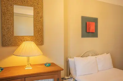 a bedroom with a bed and a lamp on a table at Timeless Elegance, 2 bed Apt in Historical Building St Gervais in Saint-Gervais-les-Bains
