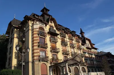 a large building with balconies on the side of it at Timeless Elegance, 2 bed Apt in Historical Building St Gervais in Saint-Gervais-les-Bains