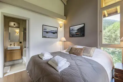 a bedroom with a large bed with towels on it at Meleze - Chalet 5CH Vues Jardin Lac Remontees 200m in Les Houches