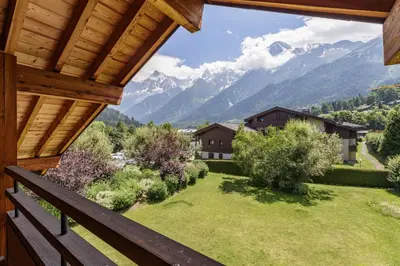a view from the balcony of a house with mountains at Meleze - Chalet 5CH Vues Jardin Lac Remontees 200m in Les Houches