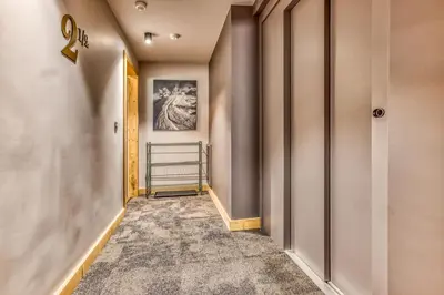 a corridor of a hallway with a hallway at Turra - Cosy 80m2 Central Remontee Parking Calme in Les Houches