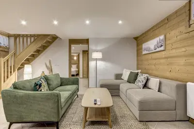 a living room with two couches and a table at Mouilles - Apart 113m2 Jardin Calme Garage Bar Centre in Chamonix-Mont-Blanc