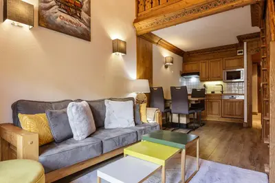 a living room with a couch and a table at Cristal - Duplex Sauna Parking Remontee 300m Balcons in Chamonix-Mont-Blanc