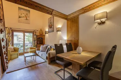 a living room with a table and chairs at Cristal - Duplex Sauna Parking Remontee 300m Balcons in Chamonix-Mont-Blanc