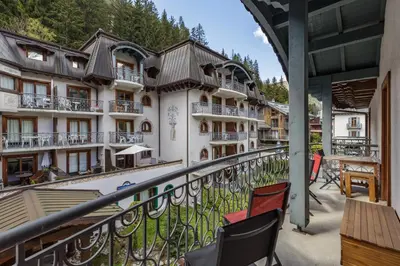 a balcony of a hotel with chairs and tables at Cristal - Duplex Sauna Parking Remontee 300m Balcons in Chamonix-Mont-Blanc