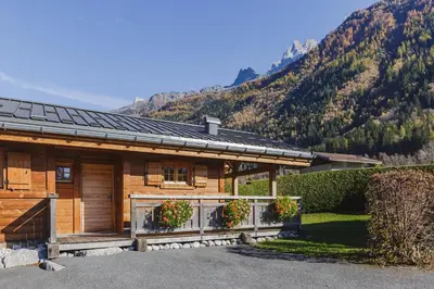 a log cabin with mountains in the background at Barrats Vert - Mazot Hypercentre 1km Nature Vues Calme in Chamonix-Mont-Blanc