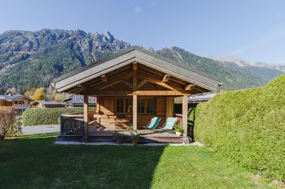 a pavilion with chairs and mountains in the background at Barrats Vert - Mazot Hypercentre 1km Nature Vues Calme in Chamonix-Mont-Blanc