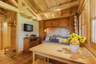 a bedroom with a bed and a table with flowers at Barrats Vert - Mazot Hypercentre 1km Nature Vues Calme in Chamonix-Mont-Blanc