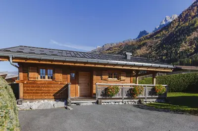 a log cabin with mountains in the background at Barrats Vert - Mazot Hypercentre 1km Nature Vues Calme in Chamonix-Mont-Blanc