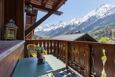 a balcony with a table and a view of mountains at Petit Balcon - Cosy 1CH Remontees 500m Vue Parking Calme in Les Houches