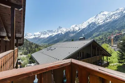 a balcony of a cabin with a view of mountains at Petit Balcon - Cosy 1CH Remontees 500m Vue Parking Calme in Les Houches