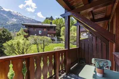 a balcony of a cabin with a view of the mountains at Petit Balcon - Cosy 1CH Remontees 500m Vue Parking Calme in Les Houches