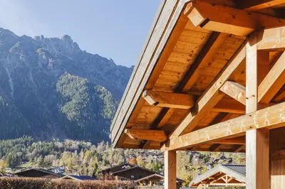 a wooden building with mountains in the background at Barrats Rouge - Mazot Hypercentre 1km Nature Vues Calme in Chamonix-Mont-Blanc
