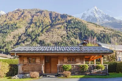 a log cabin with a mountain in the background at Barrats Rouge - Mazot Hypercentre 1km Nature Vues Calme in Chamonix-Mont-Blanc
