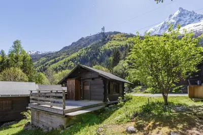 a cabin in the mountains with mountains in the background at Baribal - Charmant Mazot Terrasse Nature Vue Parking in Chamonix-Mont-Blanc