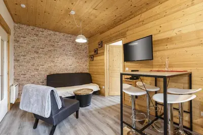 a room with a bed and a table and chairs at Epicea - Cosy 1CH 35m2 Centre Parking Calme WIFI in Chamonix-Mont-Blanc