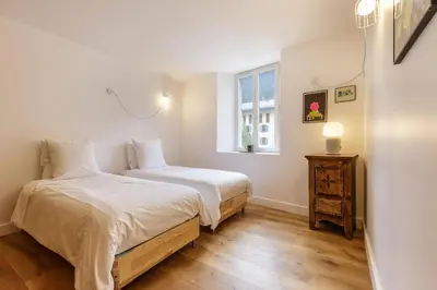 a bedroom with two beds and a window at Cinema - Lumineux Moderne 2CH 100m2 Hypercentre Vues in Chamonix-Mont-Blanc